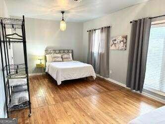 bedroom with wood-type flooring