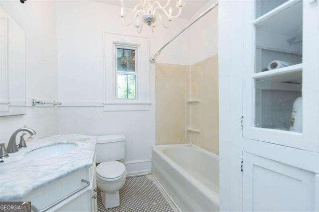 full bathroom with an inviting chandelier, tile patterned flooring, toilet, vanity, and shower / bathtub combination