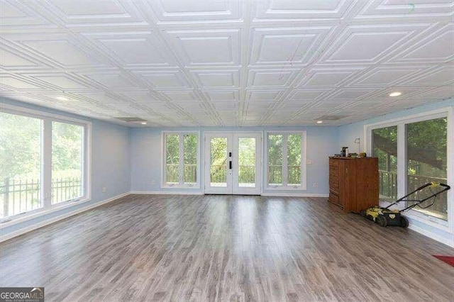 unfurnished sunroom with a wealth of natural light and french doors