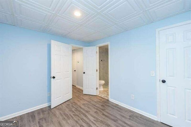 unfurnished bedroom featuring hardwood / wood-style floors