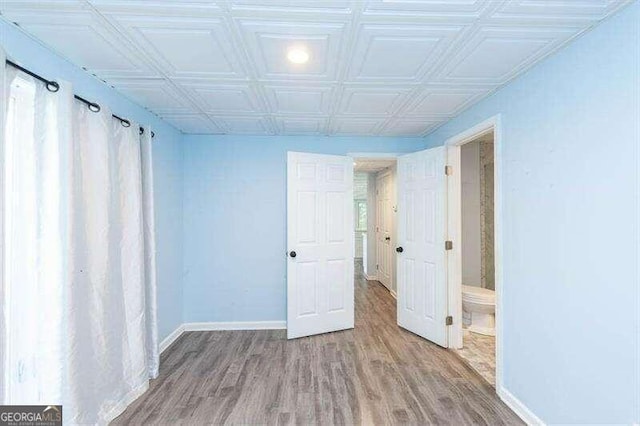 unfurnished room with hardwood / wood-style floors