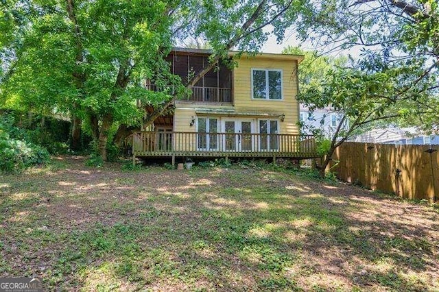 back of property with a wooden deck