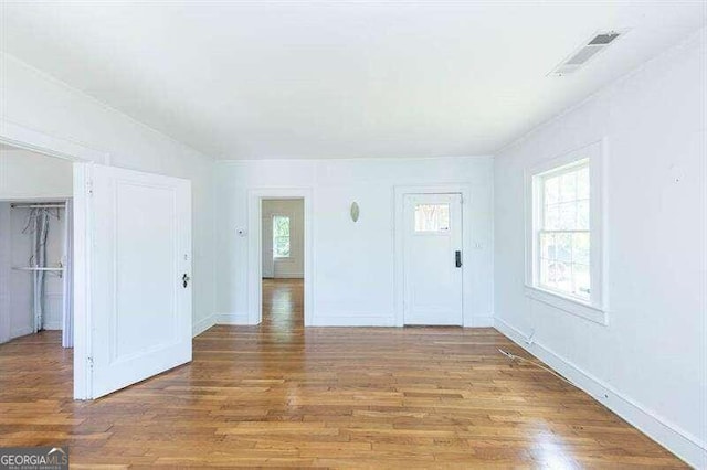 spare room with hardwood / wood-style floors