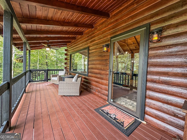 deck featuring covered porch and ceiling fan