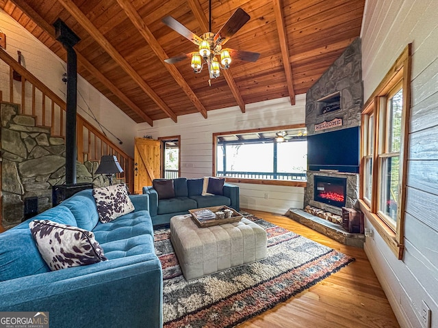 living room with wooden ceiling, ceiling fan, hardwood / wood-style flooring, and beamed ceiling