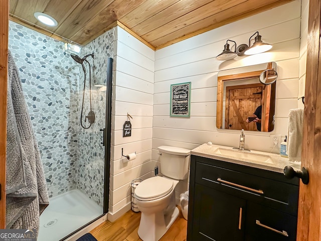 bathroom with wooden ceiling, tiled shower, hardwood / wood-style flooring, wood walls, and vanity