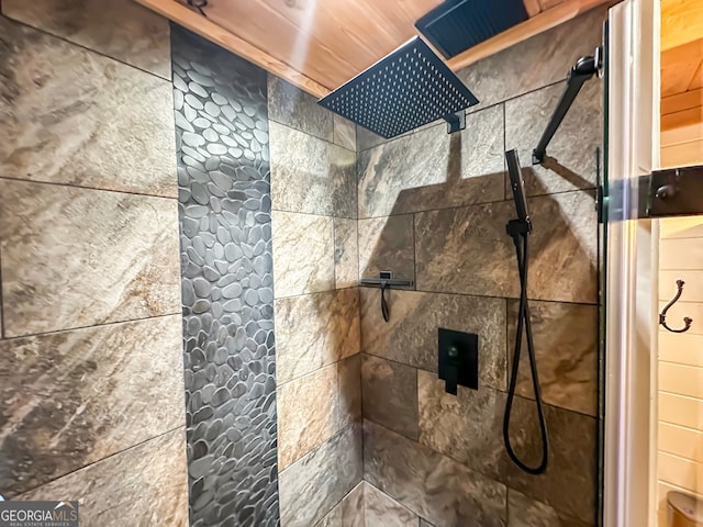 interior details featuring wood ceiling and a tile shower