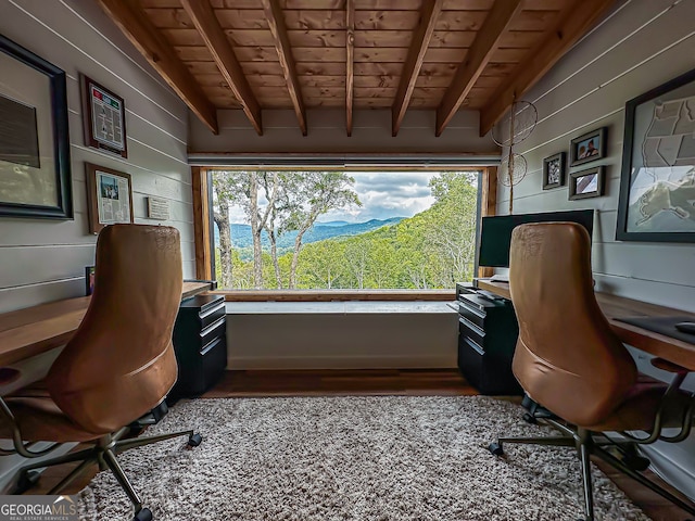 office with wooden walls, wooden ceiling, and beamed ceiling