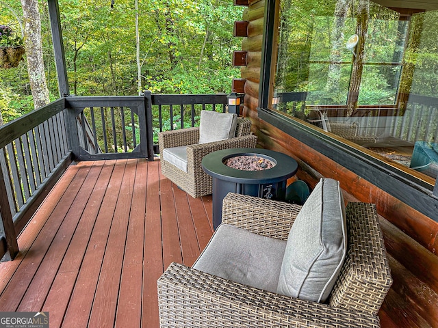 deck featuring an outdoor fire pit