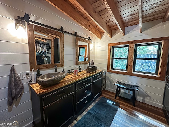 bathroom with wooden walls, lofted ceiling with beams, hardwood / wood-style flooring, and wood ceiling