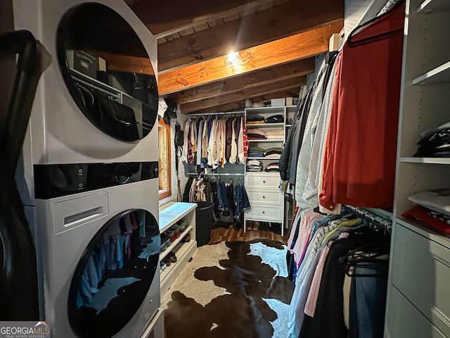 laundry area featuring stacked washer / drying machine