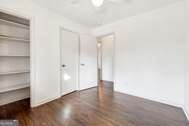 unfurnished bedroom featuring dark hardwood / wood-style floors and ceiling fan