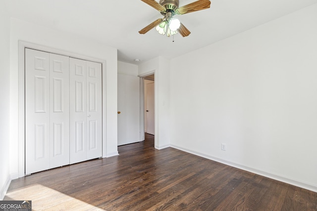 unfurnished bedroom with a closet, ceiling fan, and dark hardwood / wood-style flooring