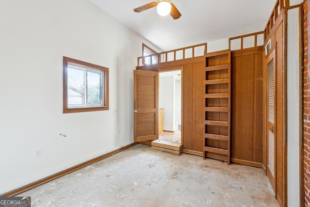 unfurnished bedroom featuring a towering ceiling and ceiling fan