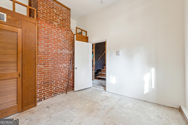 unfurnished bedroom with brick wall