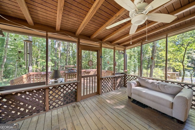 unfurnished sunroom with ceiling fan, beamed ceiling, and wood ceiling