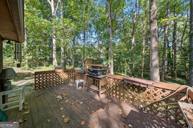 wooden deck with a grill