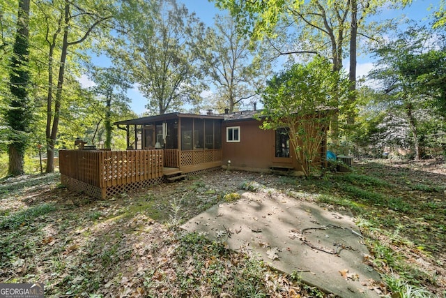 view of yard with a sunroom, a patio, and a deck