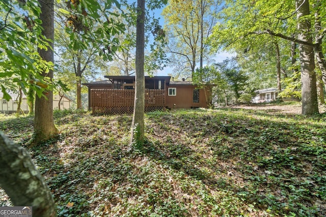 view of yard featuring a wooden deck