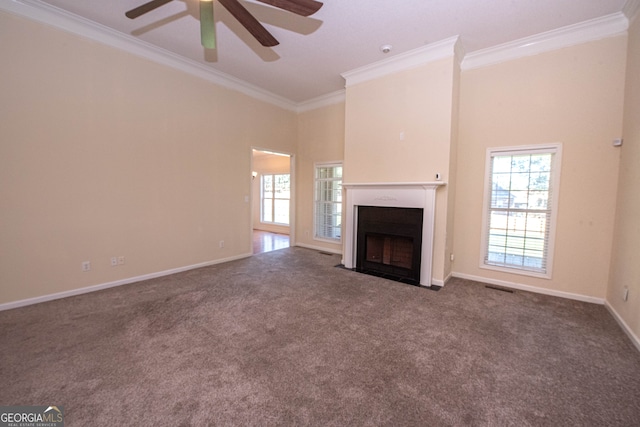 unfurnished living room with a towering ceiling, crown molding, carpet, and ceiling fan