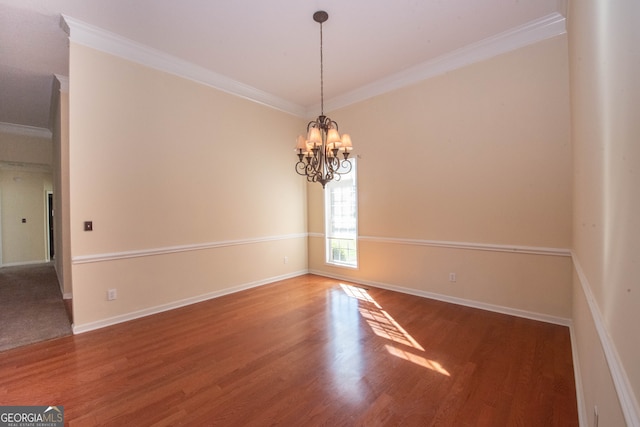 unfurnished room with wood-type flooring, a notable chandelier, and crown molding