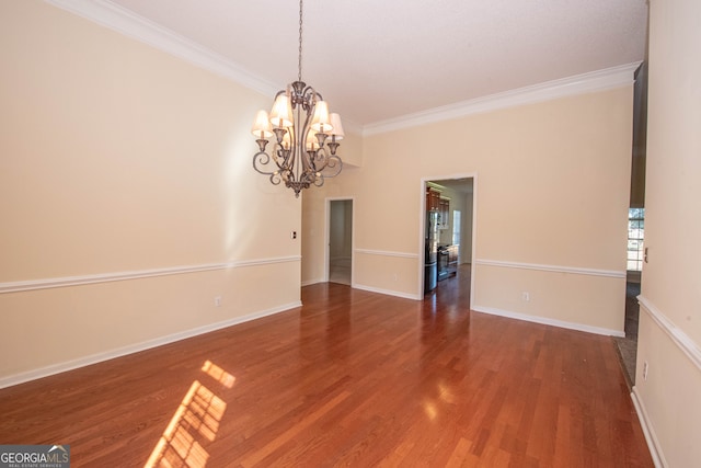 unfurnished room with ornamental molding, hardwood / wood-style floors, and a chandelier