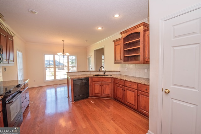 kitchen with hanging light fixtures, sink, kitchen peninsula, black appliances, and hardwood / wood-style flooring