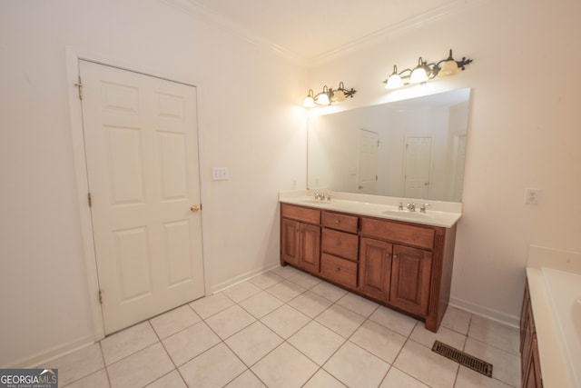 bathroom with ornamental molding, tile patterned floors, and vanity