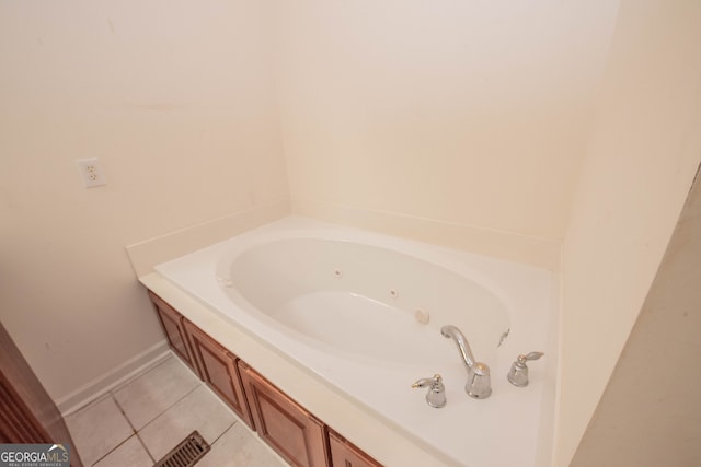 bathroom with a tub and tile patterned floors