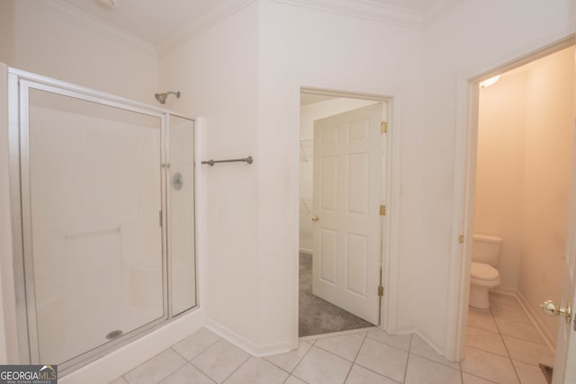 bathroom with ornamental molding, tile patterned flooring, walk in shower, and toilet