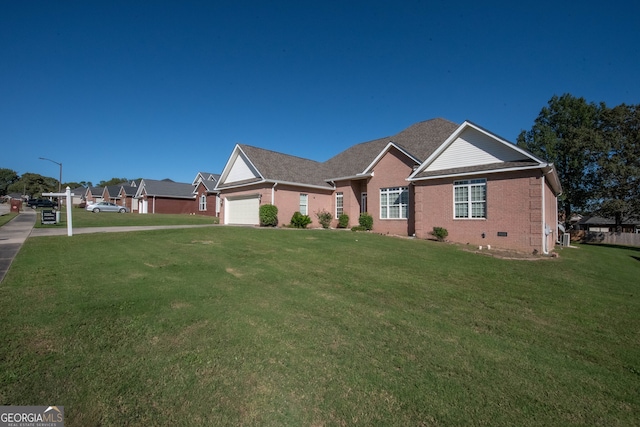 view of front of property featuring a front lawn and a garage