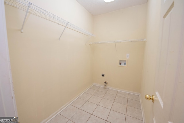 clothes washing area with hookup for a washing machine, light tile patterned floors, and electric dryer hookup