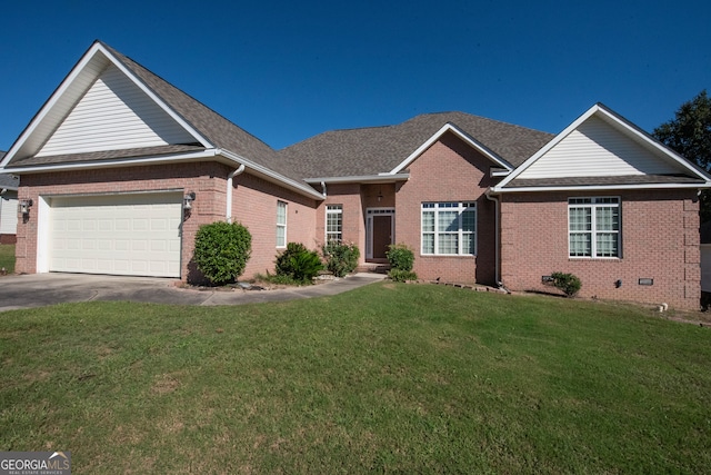 view of front of property featuring a front yard and a garage