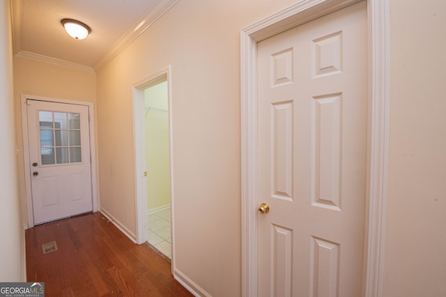 hallway featuring crown molding, dark hardwood / wood-style flooring, and a textured ceiling