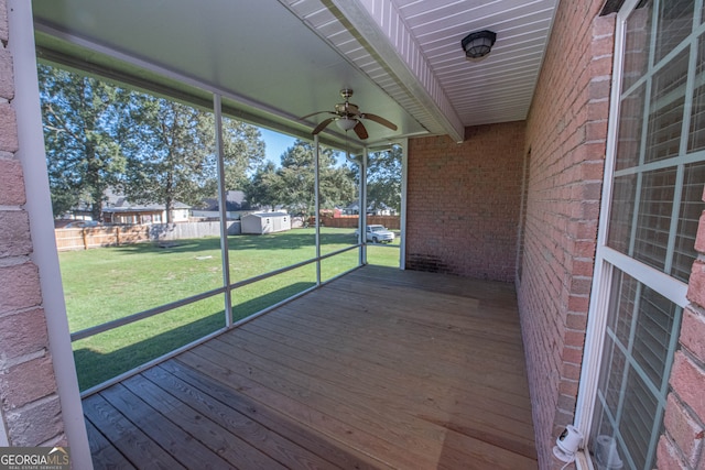 unfurnished sunroom featuring ceiling fan