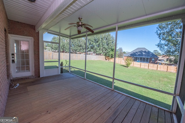 unfurnished sunroom with ceiling fan