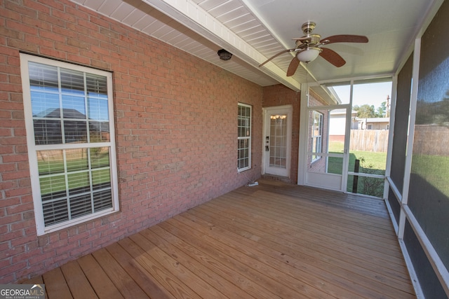 unfurnished sunroom featuring ceiling fan