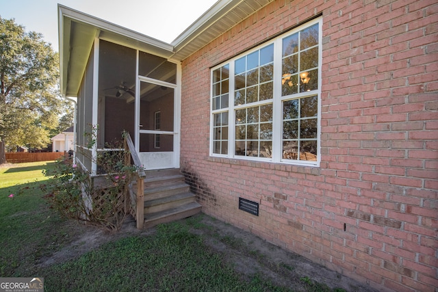 doorway to property with ceiling fan