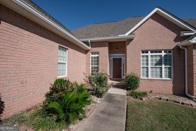 doorway to property featuring a yard