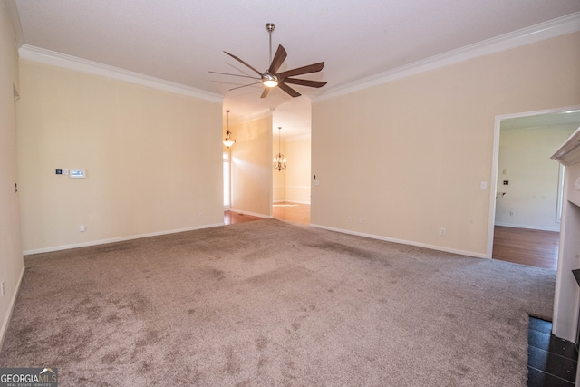 empty room featuring ceiling fan, dark colored carpet, and ornamental molding