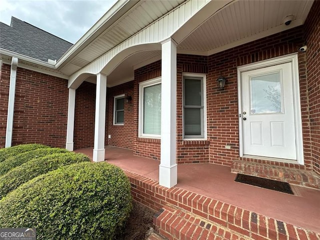 view of exterior entry with covered porch