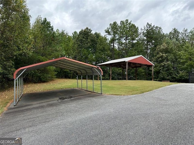 view of car parking with a lawn and a carport