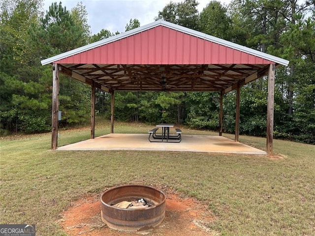 view of property's community with a gazebo, a lawn, and a patio