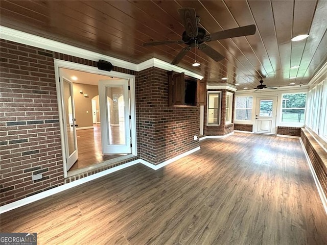 unfurnished sunroom with wood ceiling and ceiling fan