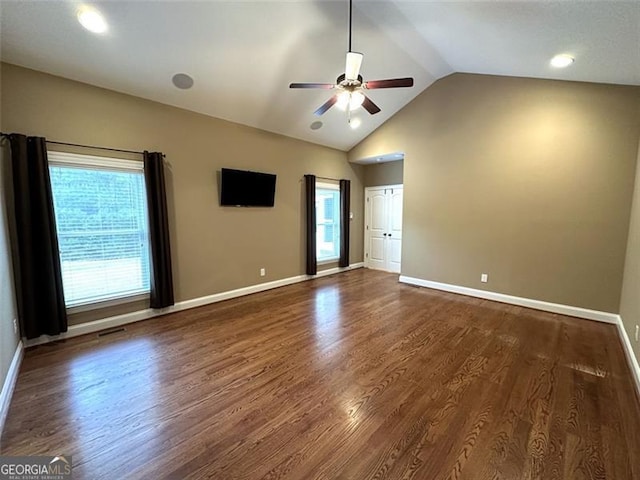 unfurnished bedroom with ceiling fan, lofted ceiling, and dark wood-type flooring