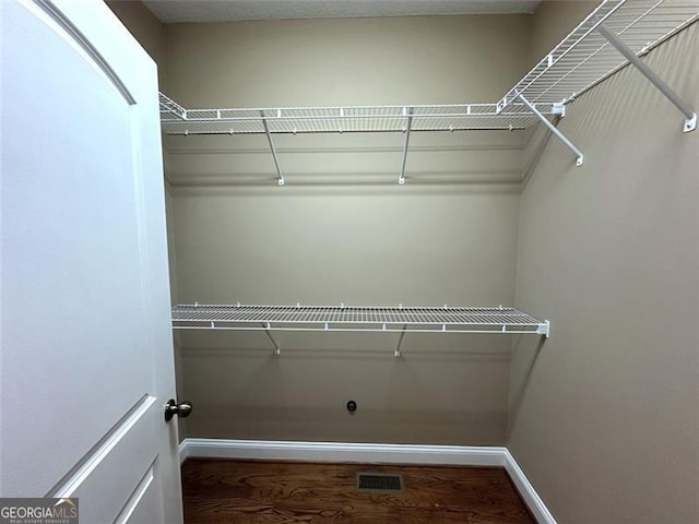 spacious closet featuring hardwood / wood-style floors