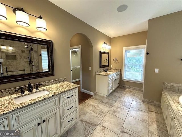 bathroom with plus walk in shower and vanity