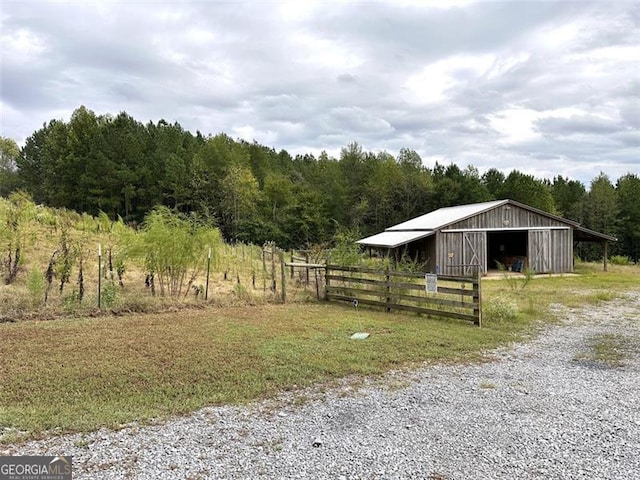 view of horse barn with a rural view