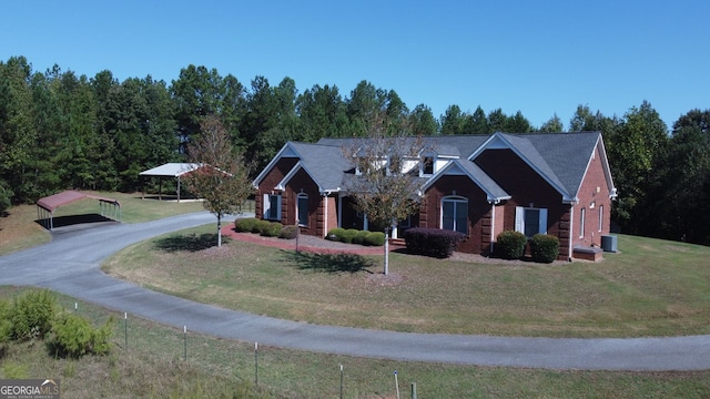 view of front facade with a front yard and a carport