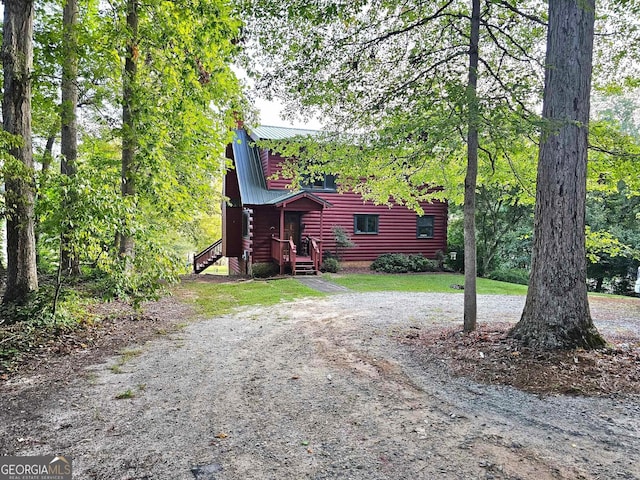 exterior space featuring metal roof and driveway